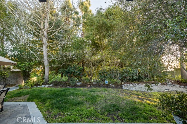 Enjoy the perfect Peninsula climate in the entertainer's backyard with grassy yard and patterned stone patio - ready for outdoor play, BBQ's, dinner parties, lounging, and relaxing with cool Palos Verdes days or under the gorgeous evening skies.