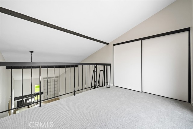 The loft offers a large closet, scraped ceilings, new carpet, and sliding doors to a second balcony!
