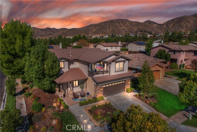 11776 Wickford Place Yucaipa, California Here's your chance to Plant Roots in a STUNNING Chapman Heights POOL home with VIEWS just in time for the holidays! This one will have you saying WOW at every turn! You'll love the professionally designed custom landscape including mature trees, bushes, flowers and hardscape including beautiful steps and custom lighting leading to the entry and front porch area. From your front porch and Executive balcony, you have beautiful serene views of the mountains! Come inside and see the gorgeous wood look tile throughout! This floorplan is perfect for entertaining! You are welcomed into the front living area with big windows overlooking your incredible backyard! Every downstairs window features custom shutters! A formal dining area sits at the center of the downstairs. Your family room is just off the dining area with cozy fireplace and mantle. Your kitchen is amazing featuring beautiful granite counters, stainless steel appliances and crisp white cabinets that pop against the warm tones of granite counters and backsplash. Custom center island is included as well! The kitchen extends into the living area with ample counter space and additional storage great for games or decor! Don't miss the WALK-IN PANTRY, too! Huge laundry room is located downstairs as well as a 3/4 bathroom with shower! Head upstairs to 3 bedrooms and 2 more full baths! All 3 of the bedrooms feature amazing views! The Executive suite even includes bonus area great for reading, exercising or an office! Have morning coffee on your BALCONY and enjoy the beautiful mountain views.The Executive bathroom features dual sinks, walk in closet, and a separate soaking tub and shower! If you've been looking for paradise, you've arrived - it's your back yard!!!! Everything you could ever need or want to entertain! Gorgeous custom features from flagstone on the patio and pool deck. A beautiful covered patio sits just off the living room. A custom flagstone Gas firepit is centered in the yard with beautiful stained concrete area perfect for gathering and lounging alike! Have green grass all year long with top grade synthetic grass throughout the yard. Finally, a beautiful salt water pebble tech "spool" featuring Baja Shelf for tanning and 3 sheer descents- aka waterfalls! !The pool can be heated by 400kbtu natural gas and has a remote allowing you to activate 12 jets and color changing LED light . Run Run Rudolf, to this sought after Chapman Heights home, and make it your new Home for the Holidays!
