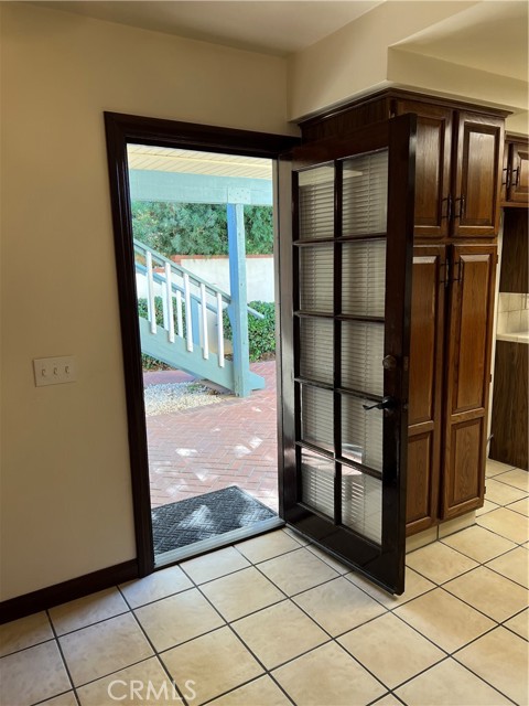 Door off the kitchen and dinette showing stairway to second level.
