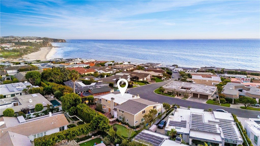 Step into a world of timeless sophistication and refined coastal living within the prestigious guarded gates of Monarch Bay in Dana Point. This exceptional residence boasts breathtaking panoramic ocean and Catalina Island views as your daily backdrop. Designed with an open and airy layout, this home embodies elegance and offers an unparalleled lifestyle of beauty and relaxation. From nearly every principal room, enjoy sweeping views of the Pacific and Catalina that elevate daily living into an extraordinary experience. The ocean-view living and dining rooms are ideal for entertaining, with the dining room enhanced by a wet bar and an expansive custom 1,200-bottle wine room. The chef’s kitchen, centered around a large island, is equipped with premium Sub-Zero, Bosch, and Thermador appliances. A large bonus room with spectacular ocean views opens to a sunny deck, providing the perfect space for gatherings or quiet moments of relaxation. With generously proportioned interiors, this home is designed to accommodate both intimate living and hosting on a grand scale. The serene primary suite offers romantic ocean views, a private sitting area with a fireplace, a spa-inspired bath, and custom walk-in closets. Throughout the home, exquisite details such as soaring ceilings, hardwood and travertine flooring, plantation shutters, and crown molding underscore its timeless appeal. The expansive backyard is an entertainer’s paradise, featuring lush garden-like landscaping, a spa, custom fireplace, BBQ bar, and a five-hole putting green. As a resident of Monarch Bay, enjoy private beach access and exclusive clubhouse amenities managed by the renowned Waldorf Astoria resort. Known as one of Southern California’s most exclusive and desirable coastal communities, Monarch Bay offers an unrivaled lifestyle of privacy, luxury, and distinction. This is more than a home—it’s a lifestyle defined by elegance, coastal beauty, and timeless sophistication.