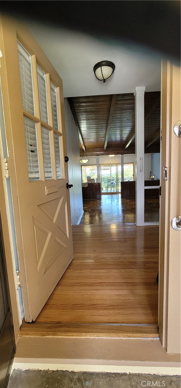 Front entry door with view towards rear large patio windows and back yard.