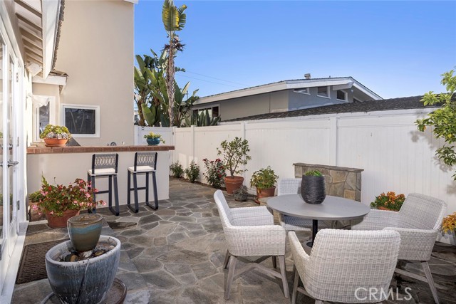 Side yard for alfresco dining near an outdoor firepit.
