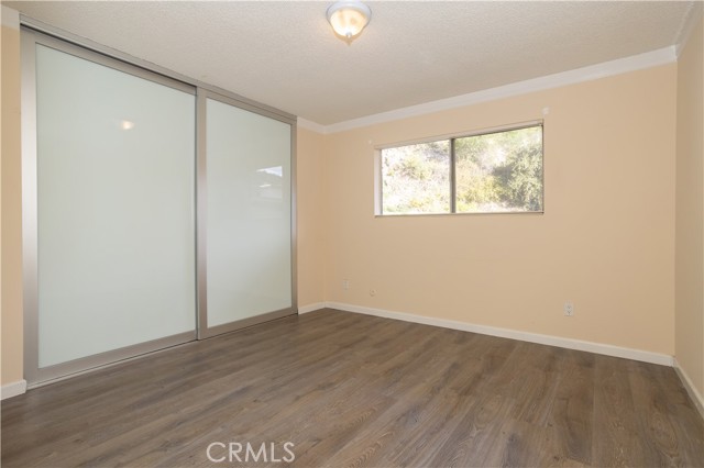 Bedroom with custom closet doors and blinds