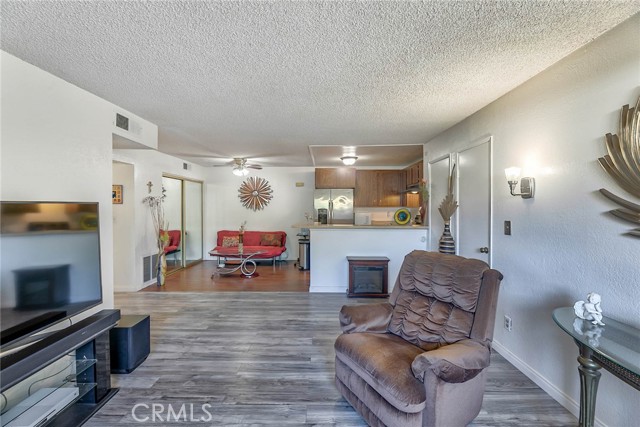 Family room open to dining area (where couch is) and kitchen with bar seating.