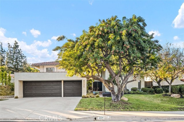 This remodeled beauty is on a quiet cul-de-sac in the heart of Classic Calabasas. Fully upgraded from top to bottom, this unique two-story home is the one you’ve been waiting for! The impressive entry with high ceilings has plenty of light flooding in from the floor to ceiling living room windows. The open concept floor plan provides a great flow between the kitchen, dining area and living room. Gorgeous hardwood flooring, French doors, modern lighting fixtures and a cozy fireplace highlight the first level. The updated kitchen has quartzite counters, Sub-zero & Thermador stainless steel appliances, breakfast bar, gold hardware and custom cabinetry.  The downstairs den has doors leading to the gorgeous yard and  is wired for a theater. The first level has one bedroom and full bath. Upstairs is the beautiful primary suite with remodeled bath, featuring Restoration Hardware vanity with carrera marble counters and walk in shower. Upstairs are two more bedrooms and fully remodeled bath with quartz counters marble floors. The yard is a beautiful retreat with modern flair. The pool has a beautiful spa and Baja shelf for great summers in the water! With plenty of room for entertaining, this yard has a covered side patio, built in barbecue and is low maintenance landscaping. Updated laundry room, super clean garage with rubber floors & Tesla charging station. In close proximity to the lake and the Commons and award winning Las Virgenes Schools - this property is a rare find!