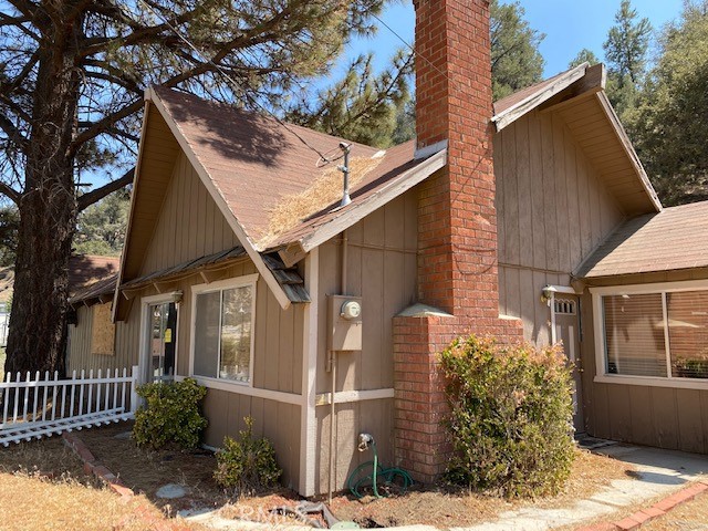TONS OF POTENTIAL! The home requires a retaining wall to be habitable. The home features a detached 2 car garage, large ceilings,  and 3 lots included with the sale. The home is on a paved road and has great views of the mountains. The seller to provide geological reports to buyer(s).