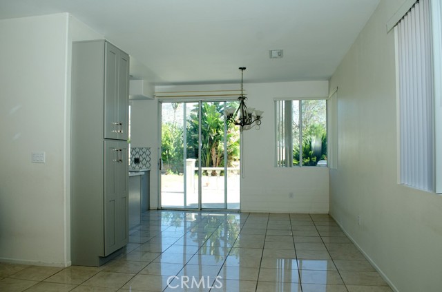 Family room looking to kitchen dining area and slider door to backyard