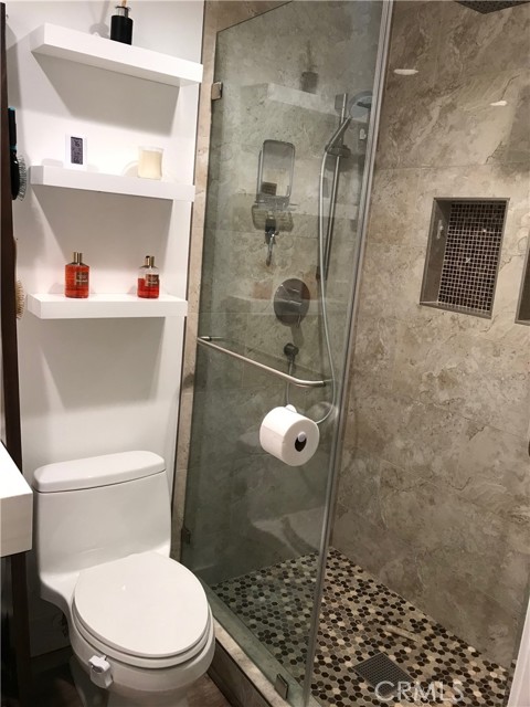 Floating shelves above toilet