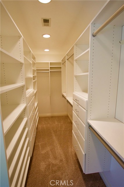 Large master closet with custom built-ins.