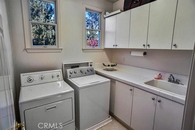 Upstairs Laundry Room with Sink and Cabinets