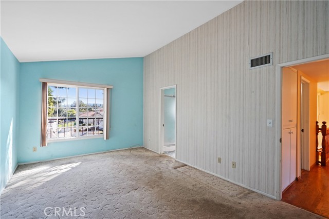 Bedroom 4 primary suite has a view looking south and has vaulted ceilings. The attached bathroom has a shower.