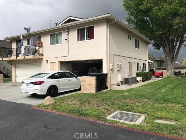 Side of property with view of garage entrance