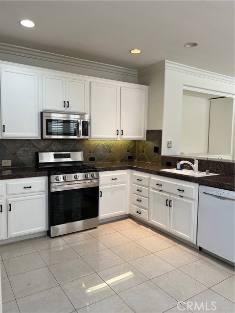 Kitchen with newer stove and microwave