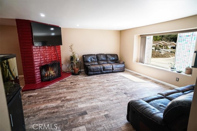 Large living room with wood burning fireplace with gas starter