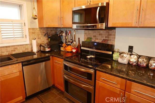 Upgraded Kitchen with Beautiful counter top, cabinets, and Tile floor.