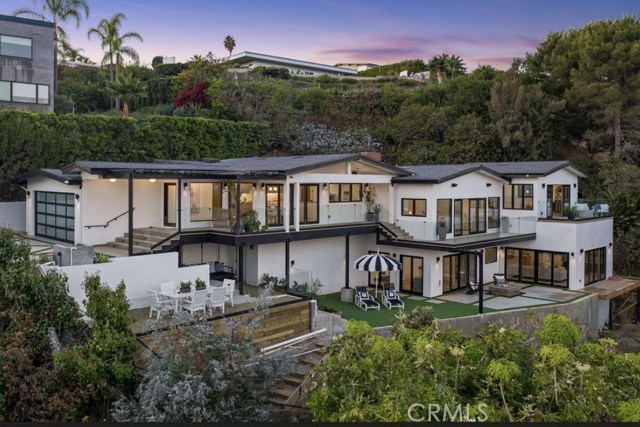 848 Lachman Lane Pacific Palisades, California Tucked away down a private gated driveway sits this spectacular renovated home, professionally and impeccably designed from top to bottom. The embodiment of clean lines, functional space and fresh modern design offers special upgrades and an abundance of natural light throughout. Large open paned energy efficient windows on every level capture the breathtaking ocean and city views. French white oak floors lead to the chefs kitchen with professional grade Thermador appliances, custom oak cabinetry, oversized center island with quartz countertops and custom glass wine room. Three secondary bedrooms, powder room, laundry/utility room and primary suite all conveniently on the main level. Secluded primary suite offers sensational views from its private deck. Luxurious primary bathroom has custom oak vanity with dual sinks and brass fixtures, large oval soaking tub, oversized shower and two walk in closets. Step down to the formal living room where volume ceilings, a large fireplace, custom builtin shelving and large glass doors flood the room with views to the horizon from the deck. Sleek glass and wood stairway off the formal living room leads down to a separate bonus room equipped with builtin bunk beds, mini bar plus one bedroom and bath. This is the perfect additional and versatile living space for a media room, game room, office or ADU. Multileveled decks and patios create a myriad of areas for diverse outdoor entertainment opportunities.