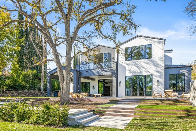 5376 ROUND MEADOW Road Hidden Hills, California This beautiful, brand new custom estate is nestled on a flat one-acre lot. Spanning 10,668 square feet of true quality and luxury living, the sunny, open floor plan is inviting and flooded with natural light. Highlights include a spectacular two story entry with ridge beam skylights, a superb chef's kitchen with two large islands, professional quality, Miele stainless steel appliances and large sunny breakfast area, all opening to the spacious great room with sliding walls of glass, leading to approximate 1, 000 square feet of covered patios, complete with a full barbecue center. Additional features include a media room with sliding outdoor serving window, large formal dining room with adjacent, glass encased, refrigerated wine display, a spacious front facing office with large picture windows, a formal living room with gorgeous, floor to ceiling fireplace, an elegant floating staircase with piano area, plus an upstairs loft. There are five spacious en suite bedrooms including the luxurious primary suite with large retreat, fireplace, all stone bath with steam shower, two huge custom closets and a walk-out balcony. The lushly landscaped ground include a sparkling zero edge pool and spa, approximate 565' pool pavilion with a second full barbecue center that also includes a pizza oven, plus a bath with outdoor shower, an adjacent bocce ball court, a fire pit, loads of flat lawn, a spacious four car garage, and room for a future guest house or stable. This is truly a model sharp custom estate.