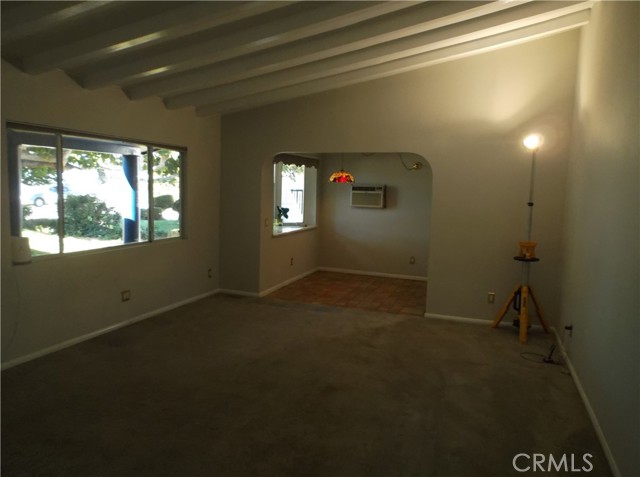 Living room looking toward dining area. Slopped ceilings throughout living areas.