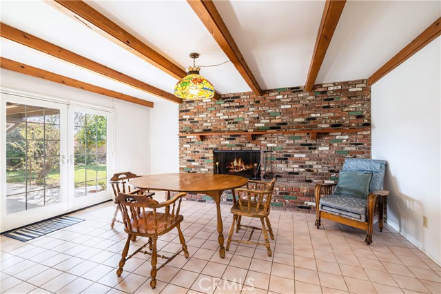 Family or dining room.  Beautiful brick fireplace.