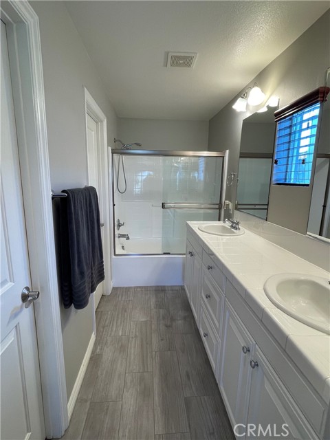 Master bathroom with dual sinks and tub/shower