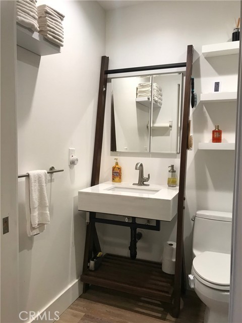 Contemporary bathroom sink and opening mirrored vanity cabinet