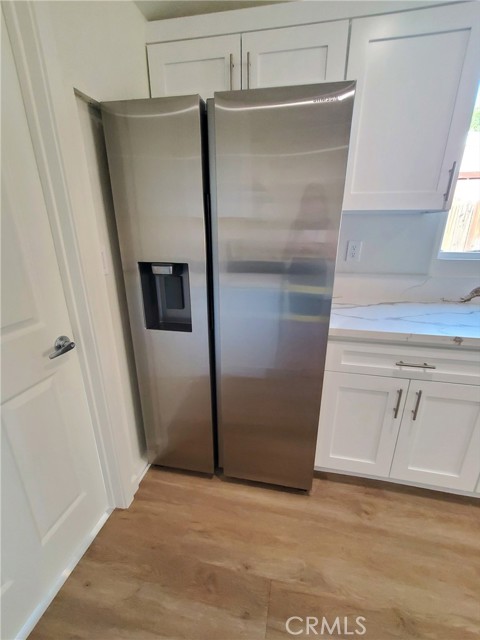 Sansung stainless steel refrigerator with icemaker.