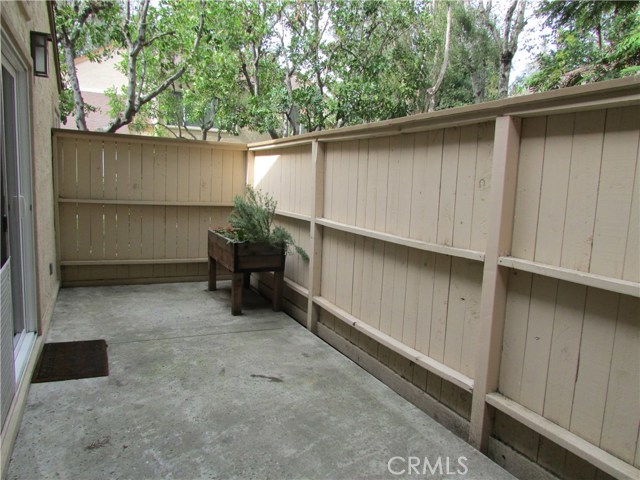 Large tree shaded private patio with gate.