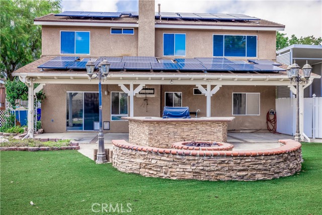 Backyard with fire pit and built in BBQ.