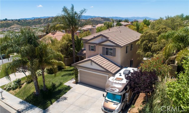 28481 Santa Catarina Road Saugus, California Looking for a gorgeous, move-in ready home with RV parking, No HOA or Mello Roos? Look no further! This home has it all. 3 bedrooms upstairs with a possible 4th bedroom downstairs (currently an open-air office). This home is light and bright with upgrades galore! Open Kitchen with walk-in pantry, large kitchen island, granite counter tops and subway tile back splash. Wood-like tile throughout the downstairs and carpet upstairs. Spacious laundry room with storage cabinets and computer nook upstairs. Vaulted ceilings in master bedroom with large walk-in closet. Tranquil, private backyard complete with a covered patio! This home is walk-able to Plum Canyon Elementary, a California Distinguished, California Gold Ribbon and Silver Award-Winning PBIS Elementary School. Restaurants and shopping center nearby. Make this home yours today! Won't last long! Check out the video for a 24/7 open house!