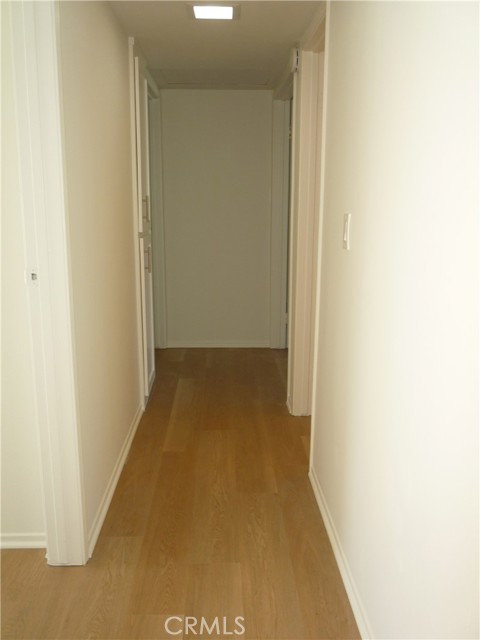 Hallway with linen storage closet