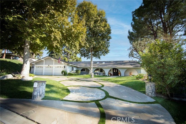 15836 Condor Ridge Road Canyon Country, California As you arrive at this gorgeous estate, you will love the curb appeal, luscious landscaping, huge front porch and lovely trees. Upon entry, you will immediately notice the large bay window overlooking the view in the yard. Take in the features such as the beautiful beamed ceilings and details around the fireplace in the living room. The dining room is adjacent to the living room making easy entertaining. Imagine your Christmas tree as a focal point, as you enter this home, in front of the large bay window. The family room is off of the kitchen and makes it easy to hang with the family while preparing meals or baking. Enjoy the large built in area in the family room to display treasures and your books. The kitchen has been beautifully remodeled and includes an eat in table too. You will love looking out of the huge kitchen window to overlook the view and the backyard pool, landscaping and patio. Needless to say, this living space is very bright and a perfect floor plan for entertaining in every room. The master bedroom is on one side of the home while the other three are on the opposite end. The master is just divine with its beveled windows showcasing the views and lovely fountain. The master bathroom has been remodeled with gorgeous touches. Lots of storage and a great retreat as it is so spacious. On the opposite hall, you will find the other 3 bedrooms, two of which overlook the backyard and boast lots of natural light! One is almost the size of the master. A remodeled bathroom to be shared with all. The laundry room is also located on this wing as well as access to the 3 car garage. You will spend most of your time outside enjoying the pool and spa while sharing meals with family and friends underneath the covered patio. BBQs will be so easy. At the end of the day, fire up the gas fire pit and share stories about your day while roasting marshmallows and taking in the amazing view. At the back of the property, find what used to be a barn. It is now being used for storage and a man cave. The possibilities are endless. Perhaps a craft room or even a conversion to a guest house. Cruise to the lower terrace where you will find yet another garden complete with fruit trees and lots of roses. This home really does have it all: VIEWS, single story, lots of upgrades inside and out, space, pool and spa, lots of landscaping and a place to just "be". A country home close to town.
