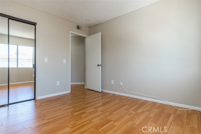 Second bedroom with mirrored closet doors