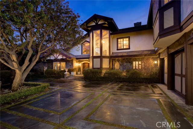 12068 Crest Court Beverly Hills, California Located in the prestigious, guard-gated community, The Summit in Beverly Hills. This Tudor style home offers luxury and convenience with quality and detail to impress. The floor plan is flooded with natural light and offers astonishing views throughout. The newly renovated Chef's Kitchen is fitted with Viking appliances, Sub-Zero refrigerators, extensive counter space, and a walk-in pantry. Additionally there is a rare, underground wine cellar to showcase your best vintages. Each of the five bedrooms have updated en-suite bathrooms. One extra large suite offers its own separate entrance and living space. The Master Bedroom suite boasts a fireplace, dual baths, dual walk-in closets, Carrera marble shower, soaking tub and dry sauna. The grounds feature an infinity pool, outdoor kitchen, cabana, plenty of room to play and incredible mountain, city light and ocean views. Perched at the top of Mulholland, and nestled in a quiet cul-de-sac, this home offers incredible privacy with convenient access to city and valley destinations a short distance away.
