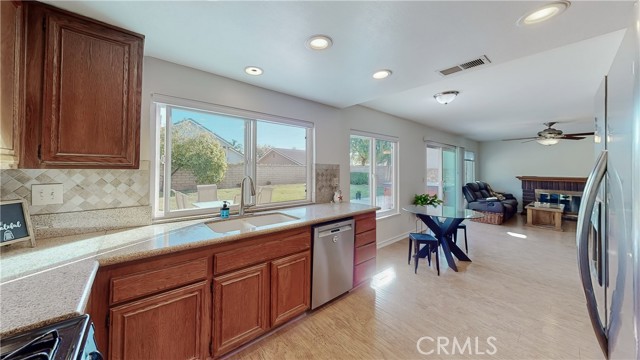 Kitchen open to eating area and family room with fireplace.  Wonderful oversized windows and slider to view your spacious backyard.  
