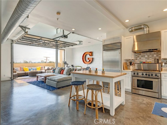 1544 12th Street 303 Santa Monica, California Santa Monica Modern Living At Its Best! This unique top floor loft-style living features 1 bed, 2 baths, approx. 1,380 sq. ft. designed by notable architects Pugh & Scarpa. The unit features open floor plan with indoor/outdoor living with a trendy roll up door that opens to the living room onto a spacious patio with city views. High ceilings with natural light throughout this property. Updated kitchen with quartz counter tops, beautiful backsplash, and high-end stainless-steel appliances. Down the hall you enter the modern master bedroom with its own en-suite bathroom, dual master sinks, quartz countertops, and a large closet. Extra cabinetry and storage throughout including a built -in Murphy bed for guest with extra closet in the hallway. Inside laundry and 2 side by side parking spots included. Great location close to the Expo Line, 10 freeway, the beach, great restaurants and retail stores.