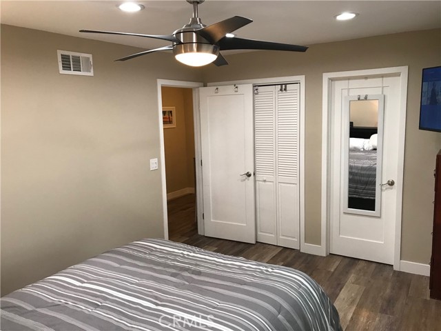 Primary bedroom with view of walk-in closet entrance, laundry room and hallway
