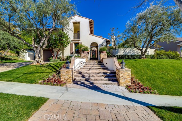 3950 Prado Del Maiz Calabasas, California Nestled on a knoll in the heart of the prestigious guard-gated community 'The Oaks' of Calabasas is an expanded Arbors- plan 4 home built by New Millennium in 2005. This charming Spanish Villa exudes a rear combination of warmth and elegance with meticulous hi-end upgrades. A welcoming, tranquil courtyard with a water fountain and fireplace will lead you into a 2 story high grand foyer. Beautifully designed living room with coffered ceiling and French doors leading to the private courtyard. A stunning guest PWD RM, 6 spacious BR suites include a casita with its own private entry for guest/in-law’s/maid/MPR as well as a bonus room on the upper level. Large formal dining. Gourmet kitchen opens to the family room, XL center island with bar seating, granite counters and stone backsplash, commercial grade SS appliances & a spacious breakfast nook. Romantic master suite with its own covered balcony overlooking the backyard & a lavish master Bath. Artesian lighting fixtures, crown moldings and custom window treatments throughout. Travertine and wood floors. Surround sound. Fabulous and SUPER private rear grounds designed for the perfect entertaining!! Large pool with custom water features, outdoor kitchen with ample counter tops and bar seating. Covered patio as well as an awning covered patio. Spanish style pavers throughout and so much more.. . Close to the community ctr.