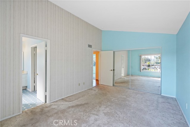 Bedroom 4 is the second primary suite with attached bath. It has a wall of mirrored closets