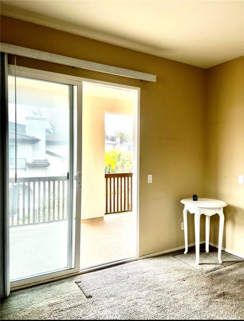 Secondary bedroom leads to balcony.