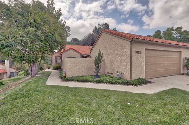 26244 Rainbow Glen Drive Newhall, California Check out this lovely 2 bedroom, 2 bath condo located in the beautiful, gated Scenic Hills Community! Great corner location, lots of privacy! Adjacent to a greenbelt, the 9th hole of the community golf course and walk-able to the awesome community amenities. Light and bright! Neutral paint, wood laminate floors, vaulted ceilings, chair rail in living, dining and hallway. Fireplace in living room with custom wood mantle. Ceiling fans in all rooms. Dual pane windows throughout. Fantastic kitchen w/ bay window, white kitchen cabinets, tile counter tops and Kenmore stainless steel appliances. Re-done Master bathroom with new: tile floor, tile shower, toilet, light fixture, medicine cabinet and framed mirror. Second bathroom has also been re-done with new: light fixture, toilet and framed mirror. Both bathrooms have satin nickel hardware; All locks, door hinges and handles have been replaced with satin nickel finish. Water heater is only 2 years old; Newer air conditioner/furnace. Copper plumbing. Relaxing outdoor space, complete w/ brick patio, grass, spacious patio cover and mood lighting. 2 car garage with laundry hook-ups and roll up garage door. Enjoy all of the fabulous amenities this community has to offer including a community clubhouse with pool table, dry sauna, workout room, library, rent-able common area with kitchen; Olympic size pool, spa, basketball court, tennis courts and BBQ area. This home and community have so much to offer! Tour today, this one won't last!