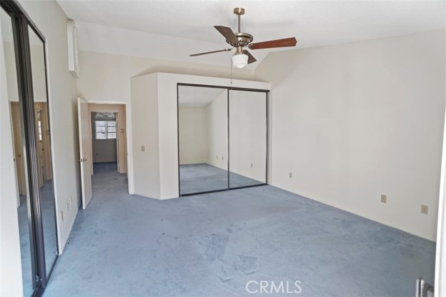 two closets with mirrored closet doors primary bedroom