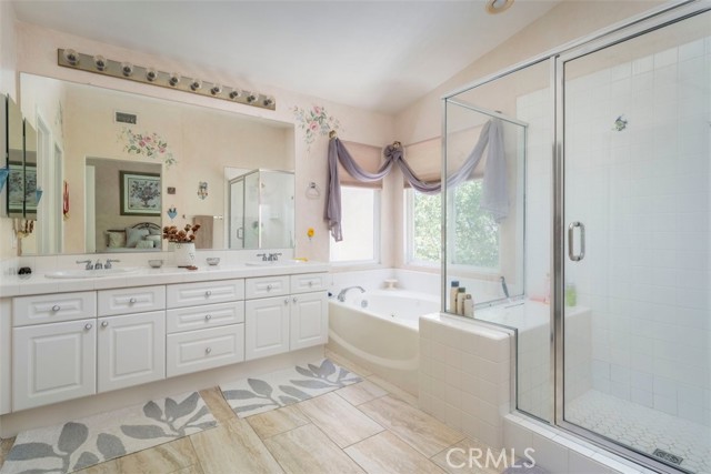 Light and bright Master bath with sunk in tub and separate shower