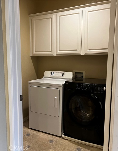 In unit laundry room with storage!