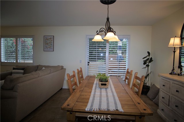 Living Room and Dining Area with View to Patio and Greenbelt