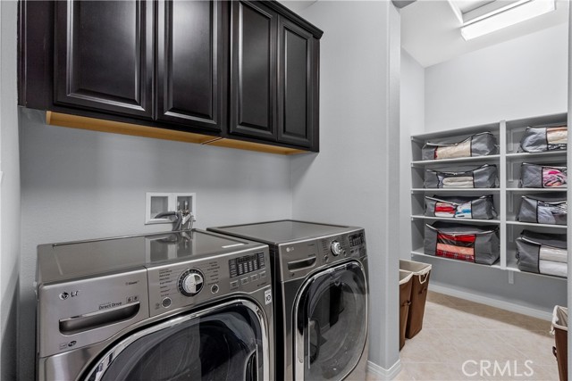 upstairs laundry with sink and extra storage