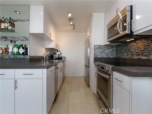 Remodeled Galley Kitchen with Quartz Countertops & Stainless Steel appliances