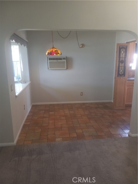 view of dining area from living room. Bay window to left.