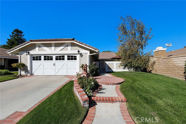 23811 Via Turina Valencia, California Exquisite single story home in the highly sought after Discovery tract in Valencia's Central Valley. Best location in town! Located on a cul-de-sac within a few steps of the Valencia paseo system known for its convenient paths to shopping, restaurants, parks and more. This home is completely updated! Beautifully landscaped, private courtyard and backyard. Gorgeous kitchen with Corian, solid surface counter tops, travertine tile back splash, gas range and custom, solid cherry wood cabinets and hood with interior and under-cabinet lighting. Milgard dual pane windows and sliders. Shutters in dining room, living room, and all bedrooms. Travertine tile floors. Solid core, interior doors with aged bronze hardware. Designer ceiling fans throughout. Extended master bathroom with a spacious, tile walk-in shower, cherry wood vanity, newer toilet and brand new mirror. Newer water heater. Copper plumbing. Utility sink and Epoxy floors in garage. Newer garage door and exterior lights in front and back. Low HOA and no Mello Roos. HOA amenities include community pools and spas and common area landscaping. Tour today, you won't be disappointed!