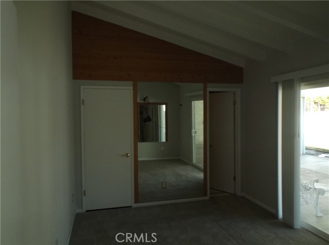 Master bedroom with bath to right with sloping ceiling.